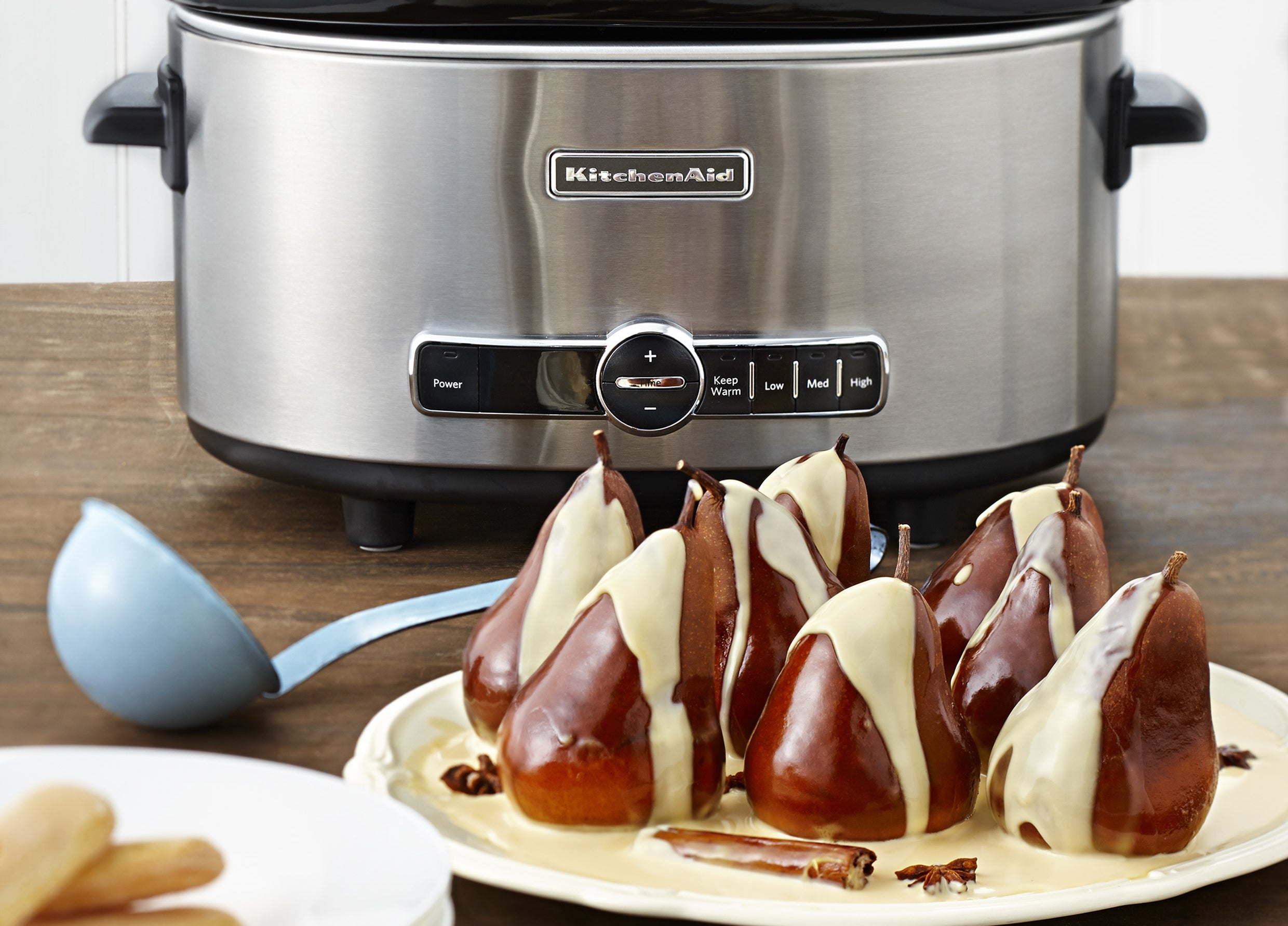 Whole poached pears in a spiced caramelised cream sauce