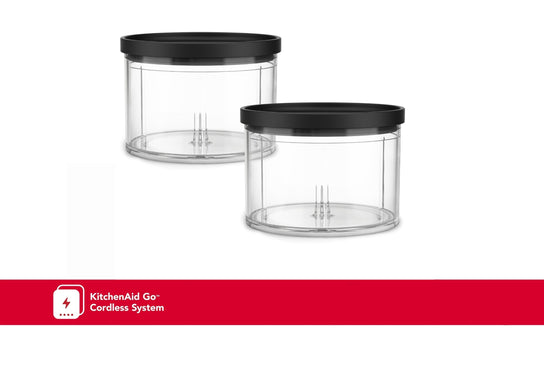 Two clear plastic chopper bowls with black lids, one larger than the other, with a KitchenAid logo in red on the bottom.