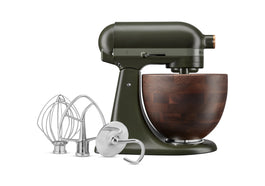 A KitchenAid tilt-head stand mixer in an Evergreen color with a wooden bowl and stainless steel attachments.